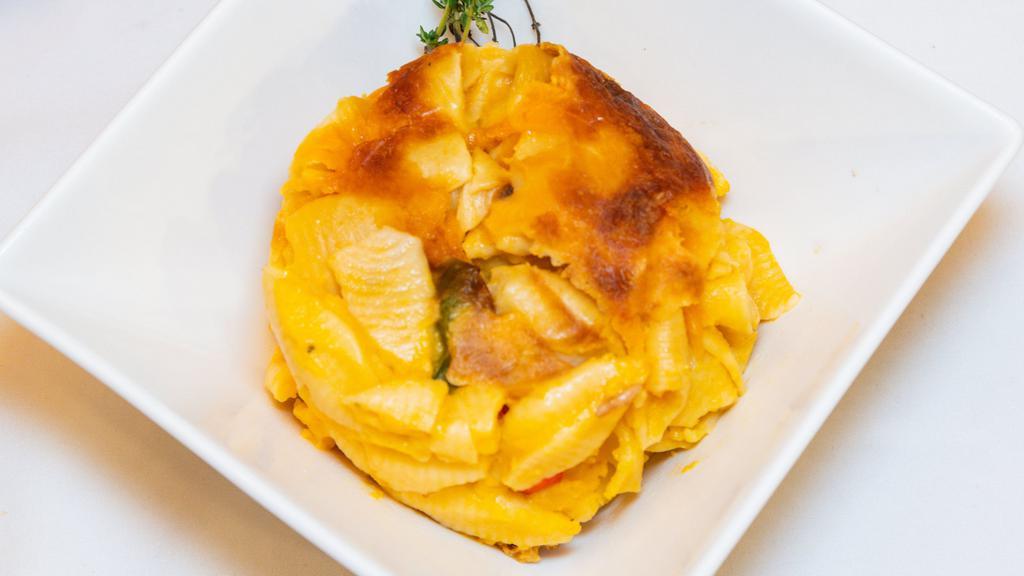 Mac & Cheese   · Macaroni pasta mixed with a blend of cheese slow baked to a gooey finish.