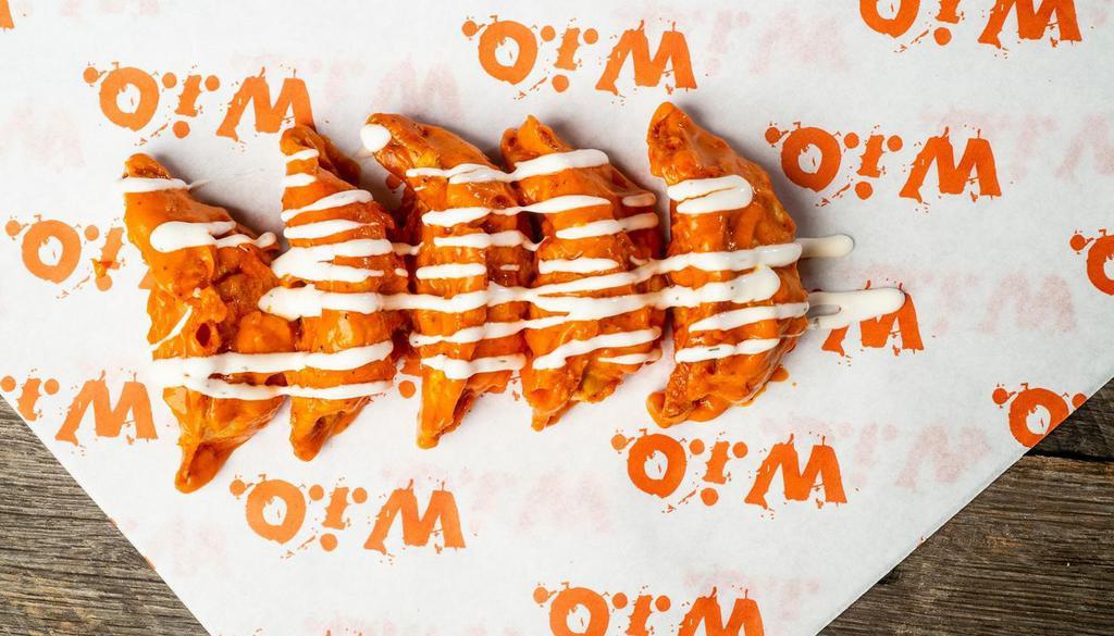 Buffalo Veggie Dumplings · Tossed in our Mild Buffalo sauce then drizzled with Buttermilk Ranch