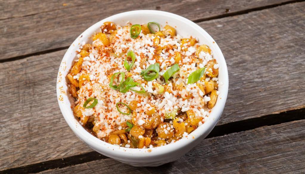 Small Street Corn · Grilled corn off-the-cob jacked up with red onion, jalapenos, scallions, chipotle ranch and topped with cotija cheese and dirty rub.