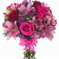Rose And Lily Celebration · this bouquet features red and pink roses, alstroemeria, wax flower and pink lilies in a clea...