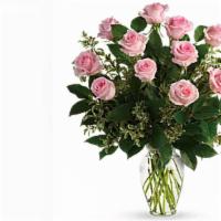 A Dozen Pink Long Stem Roses In A Vase · this bouquet features a dozen pink roses long stem in a clear vase