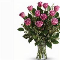 A Dozen Lavender Long Stem Roses In A Vase · this bouquet features a dozen lavender long stem roses in a clear vase