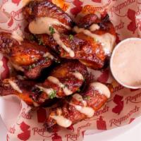 Smoked Chicken Wings · Buffalo sauce and Alabama white BBQ sauce..