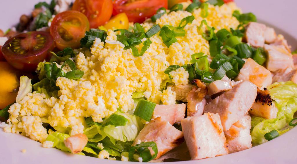 Cobb Salad · cherry tomatoes, cucumbers, blue cheese, smoked bacon, farm egg, avocado, chopped chicken, bistro dressing