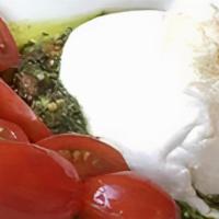 Burrata · A hand stretched mozzarella with a cream and curd filling served with arugula, tomato, & fre...