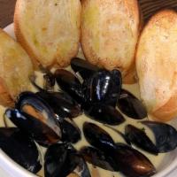 Mussels Anise · Steamed black mussels with with onions, chives, country butter, cream, and anise. Served wit...