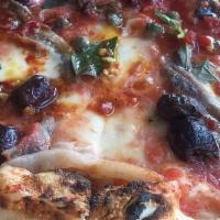 Puttanesca · An Italian classic with anchovies, Nicoise Olives, Oregano, Fior di Latte Mozzarela, and San...