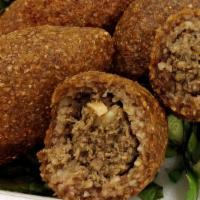 Kibbeh (3 Pieces) · Ground beef & burghul (cracked wheat) dumplings stuffed with pine nuts, onions, ground beef ...
