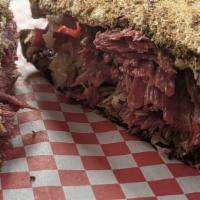 Reuben · Thinly sliced corned beef, kraut, thousand island, melted Swiss cheese, served on our toaste...