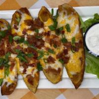 Potato Skins · Filled with cheddar jack cheese, topped with chopped bacon and scallions, served with sour c...
