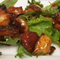Pork Belly Nibbles · Delicious smoked pork belly tossed in a tangy Thai sauce and served on a bed of mixed greens.