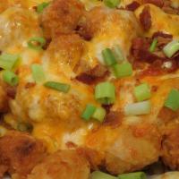 Loaded Tots · Tater tots loaded with melted Cheddar Jack cheese and crumbled bacon with ranch dressing on ...