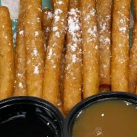 Funnel Cake Fries - With Raspberry And Caramel Sauce · Funnel Cake Fries dusted with powdered sugar.