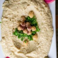 Hummus · Tasty Lebanese dip made with garbanzo beans, sesame paste, lemon juice and garlic.