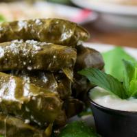 Mahshe Wark Arish · Grape leaves rolled with ground sirloin and rice topped with garlic and mint served w/side y...
