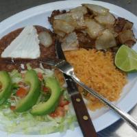 Carne Asada · Seasoned Sirlon served with, grilled cambray onion, jalapeño, rice,
beans, salad, avocado an...