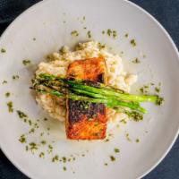 Blackened Salmon · Blackened salmon filet served with creamy risotto and asparagus drizzled with pesto