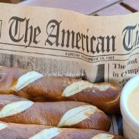 Pretzels · Four Large pretzel sticks served with Wisconsin beer cheese, stone-ground mustard or queso b...