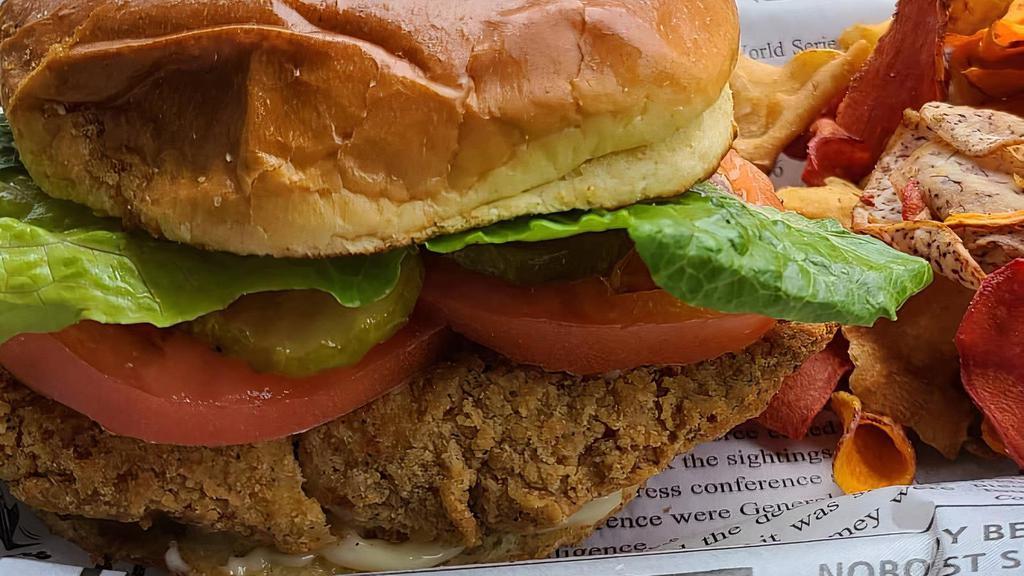 Chicken Sandwich · Generous breaded chicken breast grilled to perfection. Served on a toasted brioche bun. Topped with Alabama white sauce, tomato, pickled onions and romaine