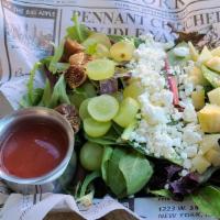 Goat Cheese Salad · Crumbled goat cheese served on a bed of mixed baby greens, dried dates, diced apples, dried ...