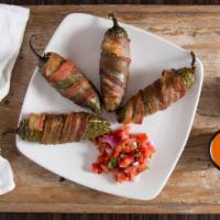 Fresh Jalapeño Poppers (4) · Gluten-free. Four whole jalapeños stuffed with our signature cheese blend and wrapped in app...