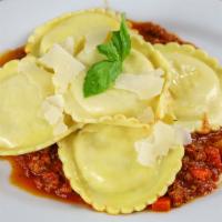 Herbed Cheese Ravioli · Four cheese ravioli over our chef's signature bolognese sauce.