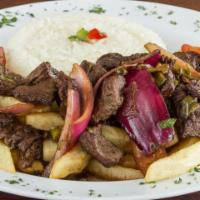 Lomo Saltado (Sautéed Beef) · Strips of beef sautéed on high flames with onions, tomatoes, soy sauce, and red wine served ...