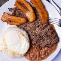 Bisteck A Lo Pobre · Flat steak served with beans, white rice, fried egg, and plantains.