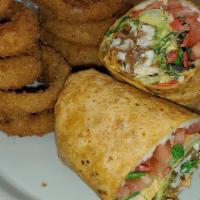 Buffalo Chicken Wrap · Hand-breaded chicken breast, avocado, tortilla strips, tomato, lettuce, mozzarella cheese an...