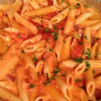Penne Alla Vodka · Penne pasta tossed with prosciutto, shallots and parmesan in a pink cream sauce with a splas...