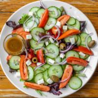 Greek Salad · Lettuce, Tomatoes, Cucumber, Feta Cheese, Red Onions, Greek Olives, Red Wine Vinaigrette