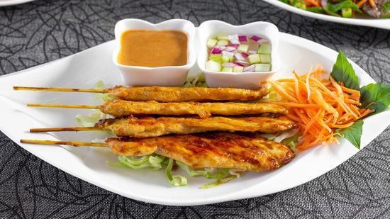 Chicken Satay (4) · Marinated chicken breast meat on a skewer with a creamy peanut sauce & cucumber & onion sauce.
