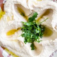 Hummus · A smooth blend of chickpeas, lemon juice, tahini (sesame sauce), and garlic. Served with pit...