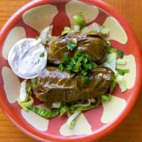 Dolma · Two grape leaves stuffed with vegetables and rice.