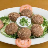Falafel · Vegetable patties. Six fried patties made with fava beans and chickpeas. Served with tomatoe...