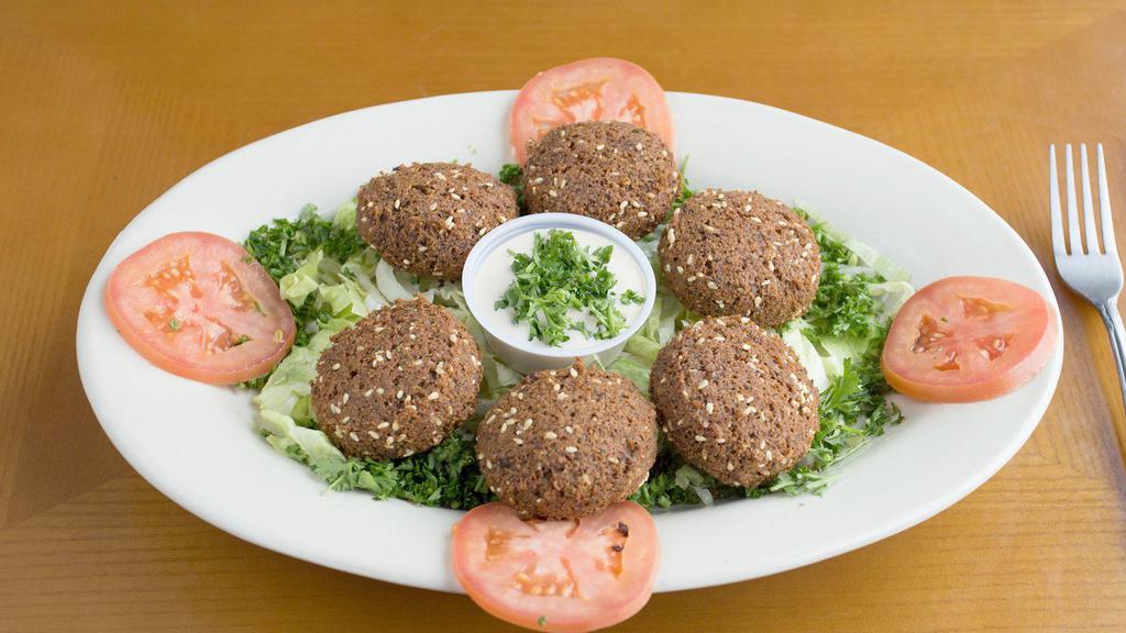 Falafel · Vegetable patties. Six fried patties made with fava beans and chickpeas. Served with tomatoes and tahini (sesame sauce).