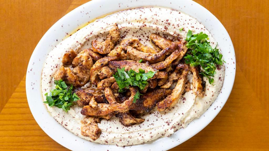Hummus And Shawarma · A generous amount of hummus topped with your choice of beef or chicken shawarma. Available in spicy. Served with pita bread and available in spicy.