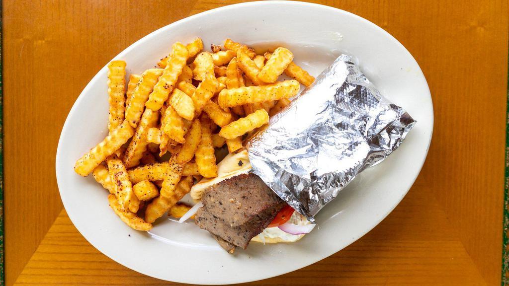 Gyros Wrap · A combination of ground beef and lamb slowly roasted over a vertical pit and thinly sliced; wrapped in thick Greek pita bread with tomatoes, onions, and tzatziki sauce. Served with a house salad and available in spicy.