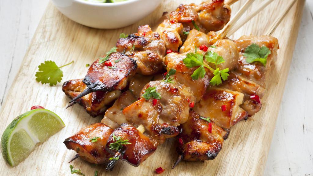 Satay · Mild spicy. Grilled tender strips of marinated chicken on skewers, served with a side of peanut sauce and cucumber relish.