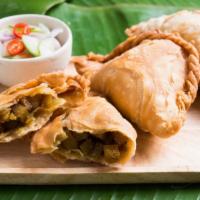 Curry Puff  · Curried minced chicken, potatoes and onions in a pastry puff, fried until golden brown and s...