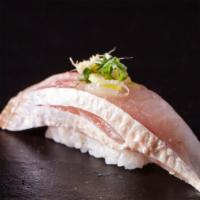 Negi Hamachi Maki (Scallion, Yellow Tail) · Gourmet sushi roll with scallion and yellow tail fish.