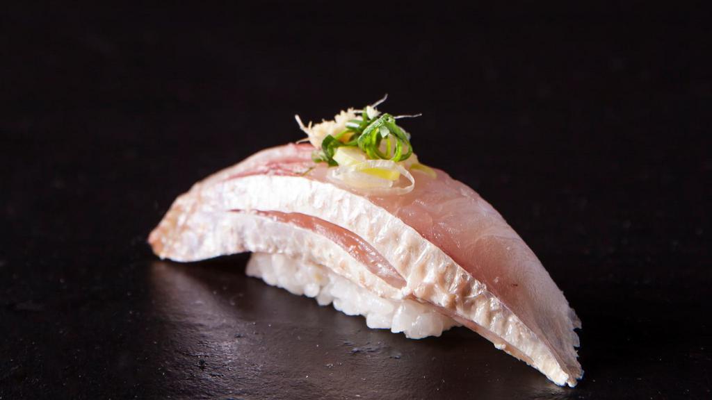 Negi Hamachi Maki (Scallion, Yellow Tail) · Gourmet sushi roll with scallion and yellow tail fish.