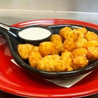 Cheese Curds · Lightly battered white cheddar curds with ranch dressing.