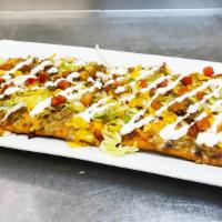 Taco Flat Bread · Our house made beef queso topped with cheddar cheese and finished with lettuce, pico de gall...