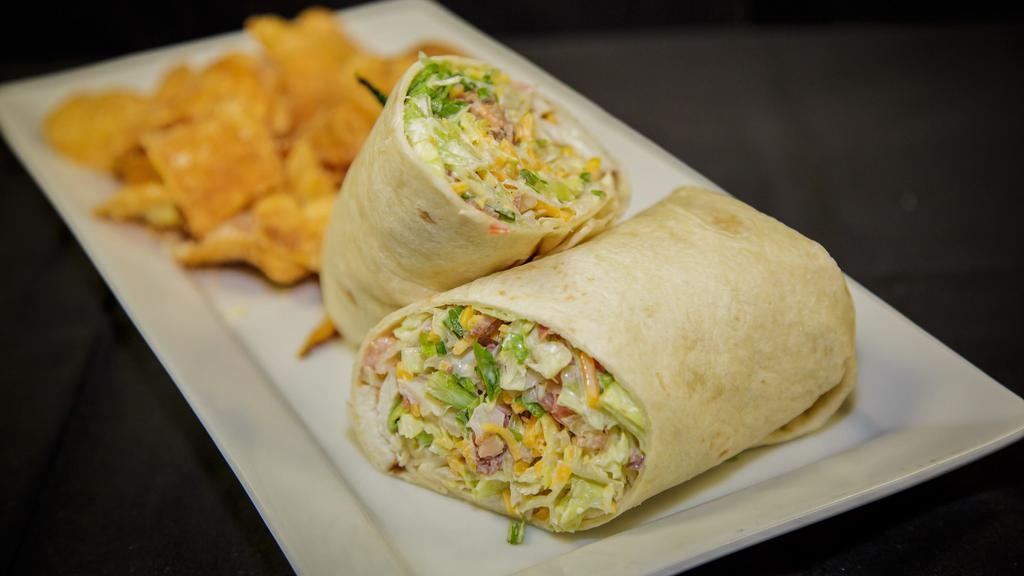 Chicken Bacon Ranch Wrap · Grilled chicken and applewood smoked bacon with lettuce, tomatoes, scallions, cheddar cheese and creamy ranch dressing in a flour tortilla.