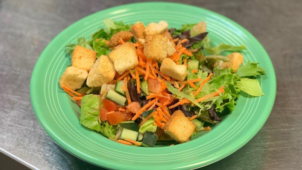 House Salad · Mixed greens with diced tomato, diced cucumber and shredded carrots. Finished with croutons and your choice of dressing.