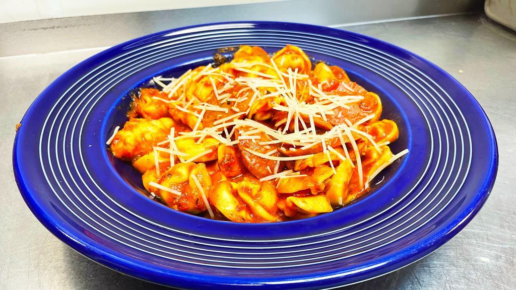 Spicy Italian · Cheese filled tortellini, grilled chicken, pepperoni, andouille sausage and crushed red pepper flakes tossed in marinara sauce.  Finished with shredded parmesan cheese