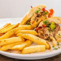 Philly Cheese Steak  · Angus beef, green & red peppers,
onions, mushrooms & swiss
cheese on a hoagie