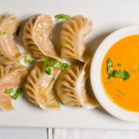 Mo : Mo (Dumpling) · Minced chicken mixed with Nepali spices and steamed inside a flour dough shell, served with ...