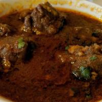Goat Curry · Tender bone in goat sauteed in ginger and garlic, marinated in himalayan spices, cooked well...